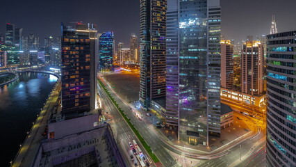 Fototapeta na wymiar Cityscape of skyscrapers in Dubai Business Bay with water canal aerial day to night timelapse