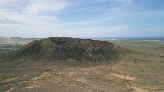 aerial fly up reveal clip of Volcan Calderon Hondo volcanic crater and volcano cone near Corralejo Fuerteventura Spain