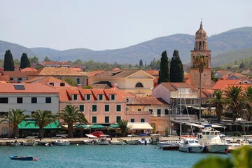 Foto op Canvas Picturesque small town Vela Luka, on island Korcula, in Croatia. Selective focus, pink oleander flowers in the foreground. © jelena990