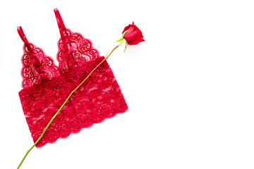 Elegant red lace lingerie bra body with red rose, top view - obrazy, fototapety, plakaty
