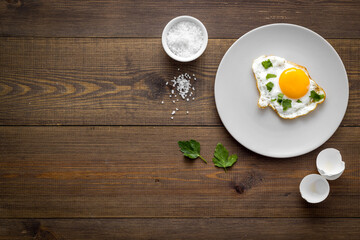 Cooking fast breakfast with fried eggs, top view. Food background