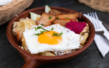 Breakfast dish - scrambled eggs with fried bacon