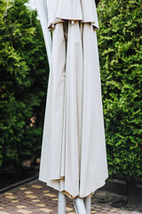 Folded sun umbrella in the park.