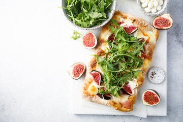 Homemade pizza with figs and arugula