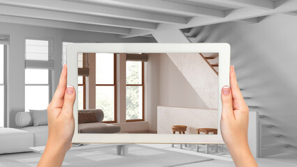 Fototapeta na wymiar Augmented reality concept. Hand holding tablet with AR application used to simulate furniture and design products in total white background, minimal living room with staircase