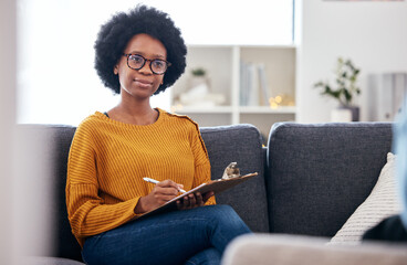 Psychologist on sofa, writing notes and listening to patient, advice and help in psychology for...