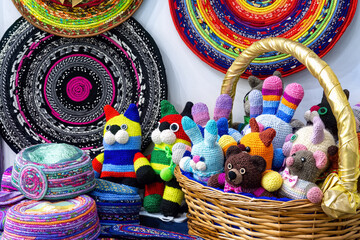 Multicolored knitted handmade children toys in basket. Homemade needlework and embroidery.