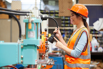 factory worker using and checking machine in the factory