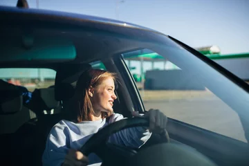 female driver driving a car on a sunny day. The pleasure of driving a car. © velimir
