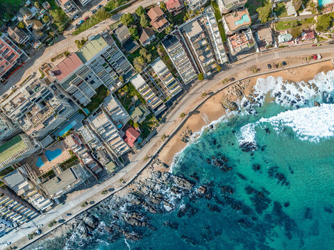 Aerial Top Down View Of Modern Luxury Seaside Apartment Buildings And Coastal Road At Playa Cochoa Beach In Vina Del Mar, Valparaiso, Chile.