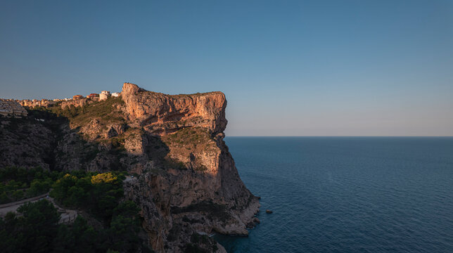 Aerial view of Breathtaking coastal panorama with clear blue sea, rugged cliffs, and serene tranquility , Zona Encinas, Cumbre del Sol, Alicante, Spain.