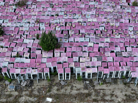 Aerial view of a phone box graveyard, a storage and dismantling facility for old phone boxes in Brandenburg, Germany.