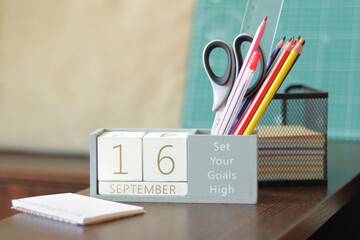 16 September. Image of september 16 wooden calendar on desktop. Autumn day. Back to school. Pencils...