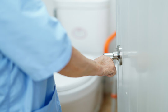 Asian Senior Woman Patient Open Toilet Bathroom By Hand In Nursing Hospital, Healthy Strong Medical. .