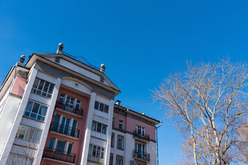 Obraz premium Modern residential multi-storey building against the blue sky.
