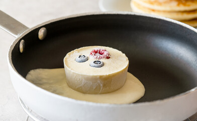 Frozen batter for pancakes are homemade preparation or trendy ice cube pancakes. Frozen batter cube in the fry pan