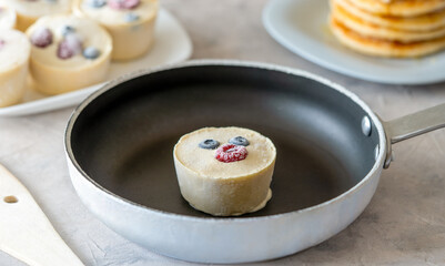 Frozen batter for pancakes are homemade preparation or trendy ice cube pancakes. Frozen batter cube in the pan