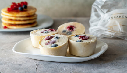 Frozen batter with berries for pancakes are homemade preparation or trendy ice cube pancakes
