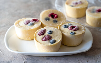 Frozen batter with berries for pancakes are homemade preparation or trendy ice cube pancakes