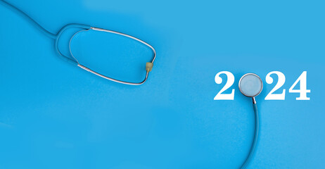 Stethoscope on a blue background with numbers 2024