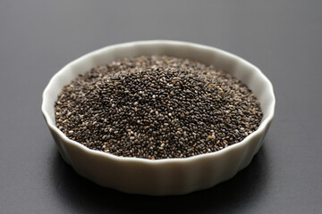 Chia seeds on dark background.