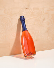 A luxurious bottle of expensive holiday champagne stands near the wooden wall. Cocktail party table.
