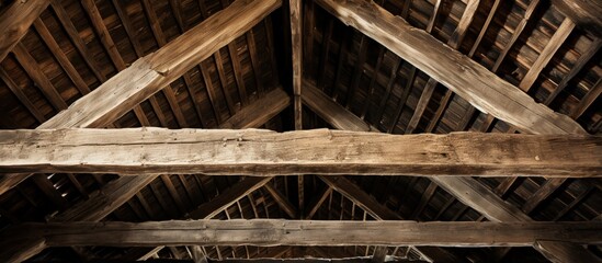 Close up view of old barn roof from below with wooden rafters
