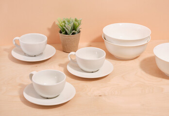 Set of white minimal tableware. Ceramic crockery. Beautiful table setting.