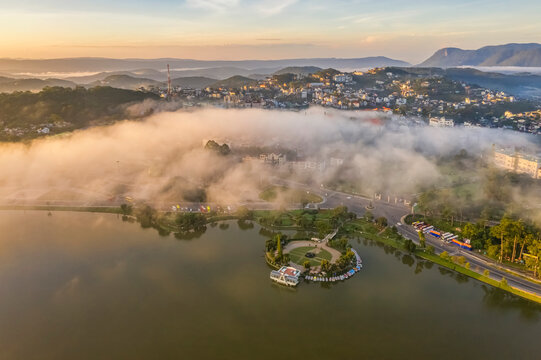 Top view aerial photo from flying drone of a Da Lat City with development buildings, transportation, nature beautifull, famoust travel city of Vietnam.