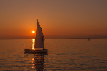 Sailboat sailing on a lake at the sunset in lake Leman, Switzerland