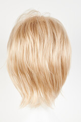 Naklejka premium Natural looking blonde fair wig on white mannequin head. Short hair cut on the plastic wig holder isolated on white background, back view.