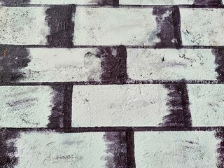 Black and white color bricks wall texture background, little stain dirty painted on bricks, Square stone bricks pattern.
