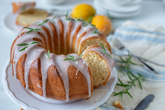 Lemon bundt cake drizzled with powdered sugar glaze