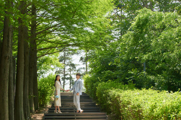 A loving couple is taking wedding photos outdoors for their wedding.