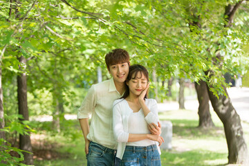 Fototapeta premium A lovely young couple are having fun in a forested park.
