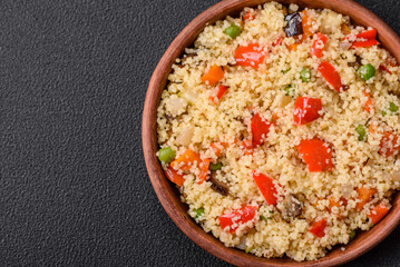 Delicious couscous porridge with cubes of grilled vegetables with salt and spices