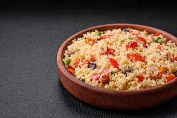 Delicious couscous porridge with cubes of grilled vegetables with salt and spices