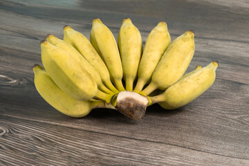 Banana on wooden background. Raw Organic Bunch of Bananas Ready to Eat. Ducasse Banana.