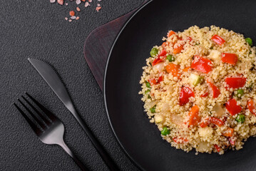 Delicious couscous porridge with cubes of grilled vegetables with salt and spices