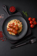 Delicious chicken or pork sausages baked on the grill with porridge and vegetables