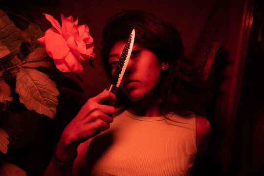 a glorious brown south asian woman with multiple poses pictures,low light, multiple colour,multiracial,psycho killer,knife