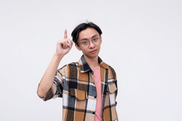 A pensive young asian man giving tips and reminders. Isolated on a white background.