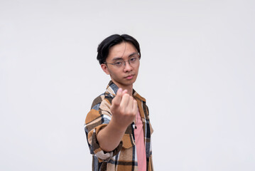 A young asian man beckons you to approach him. Gesturing to come closer. Isolated on a white...