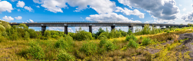 A panorama view of the Bennerley Viaduct over the Erewash canal in summertime