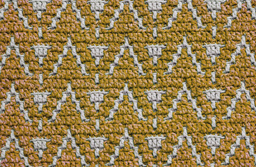 Mustard grey crochet texture with abstract mosaic pattern. Knitted background.