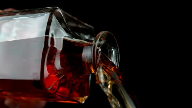 Super Slow Motion of Pouring Whiskey Drink, Camera in Motion. Filmed on High Speed Cinema Camera, 1000 fps. Speed Ramp Effect.