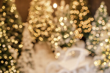 Beautiful blurred holiday decorated room with Christmas tree and bright lights , out of focus shot...