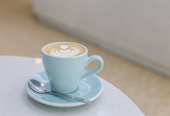 latte art tulip and heart shape in a blue cup