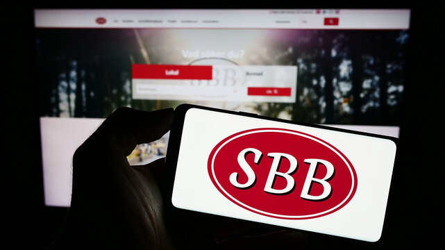 Stuttgart, Germany - 09-06-2023: Person holding cellphone with logo of Samhallsbyggnadsbolaget i Norden AB (SBB) on screen in front of business webpage. Focus on phone display.
