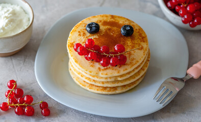 Pancakes with berries and cheese cream for funny kids breakfast